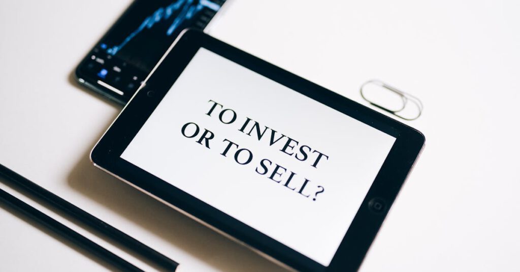 A tablet with text 'To Invest or To Sell?' on a white background.